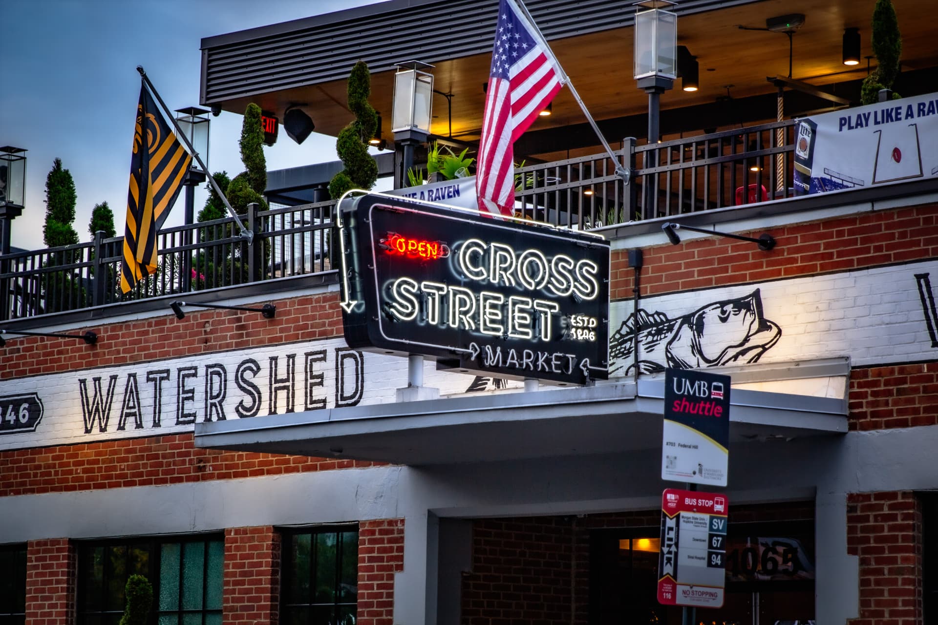 Neon Cross Street Market sign in Federal Hill
