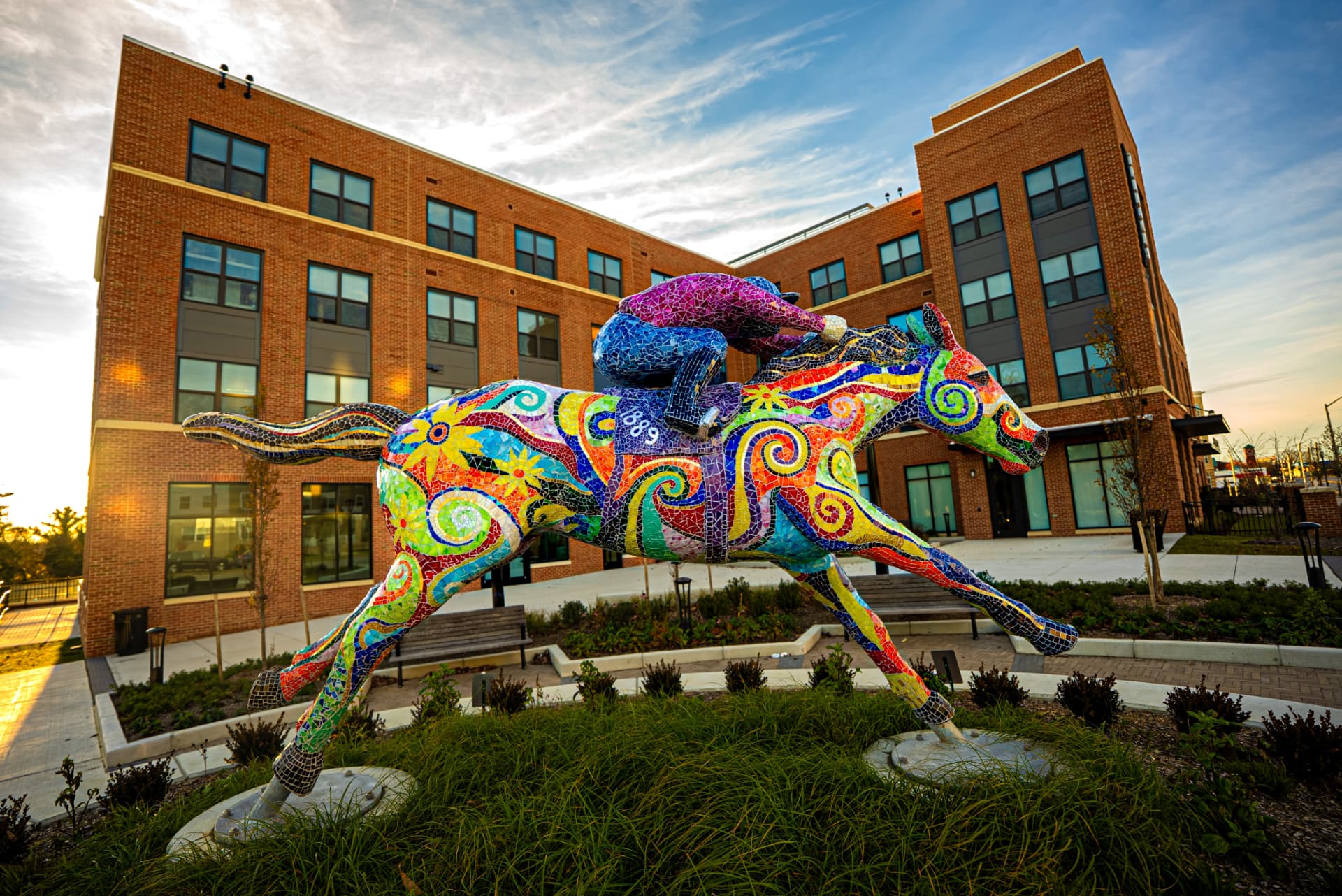 Mosaic racehorse and jockey sculpture outside a new Park Heights building